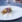 Elegantly plated gourmet dish with edible flowers and cream sauce
